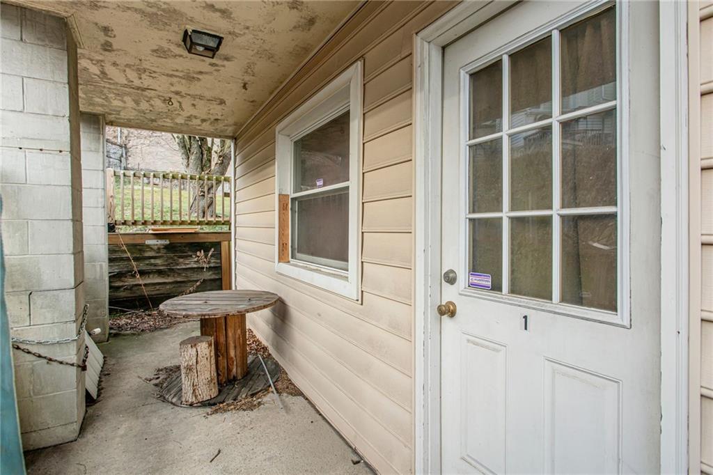 17 Locust Street Etna, PA 15223 - Photo 13 of 16 a view of a door with a chair and table