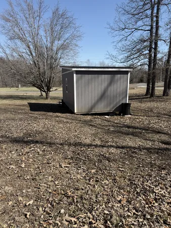 a view of backyard with wooden fence