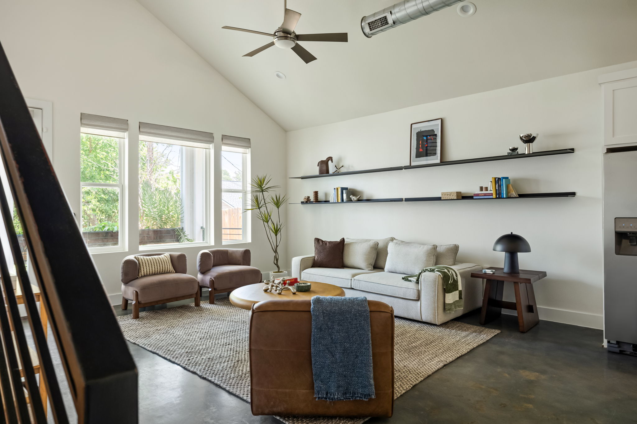 1902 Webberville Road, Unit B Austin, TX 78721 - Photo 4 of 39 An inviting living room features a vaulted ceiling, exposed ductwork, and abundant natural light.