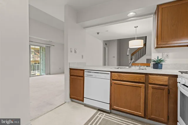 a kitchen with granite countertop cabinets stainless steel appliances a sink and a window