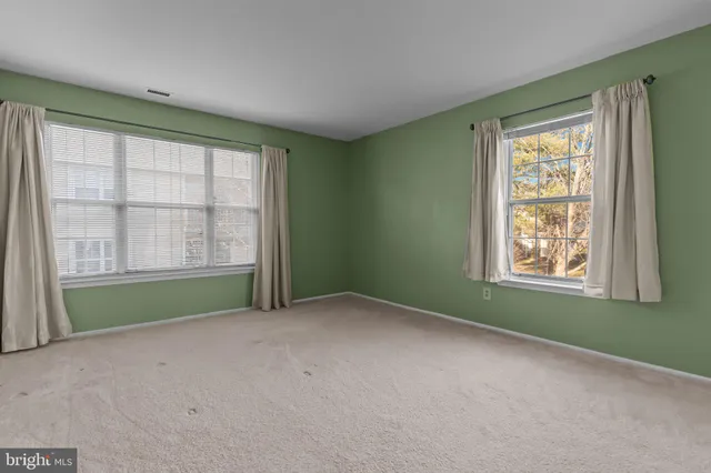 an empty room with a window and doors