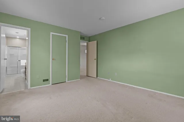 an empty room with closet and wooden floor