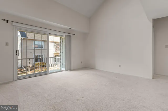a view of an empty room with a balcony