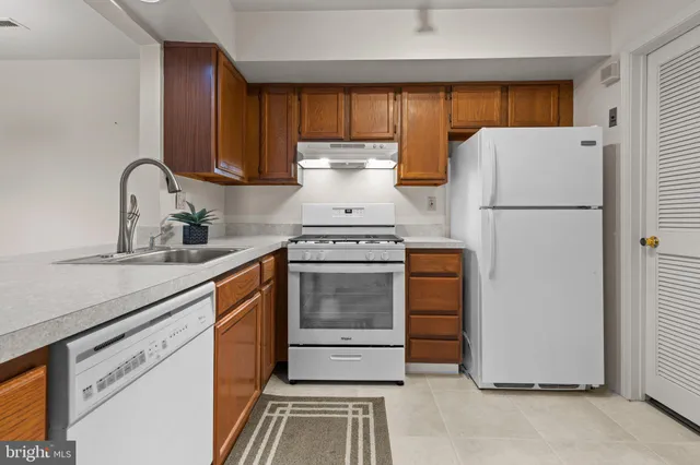 a kitchen with a stove cabinets and a refrigerator