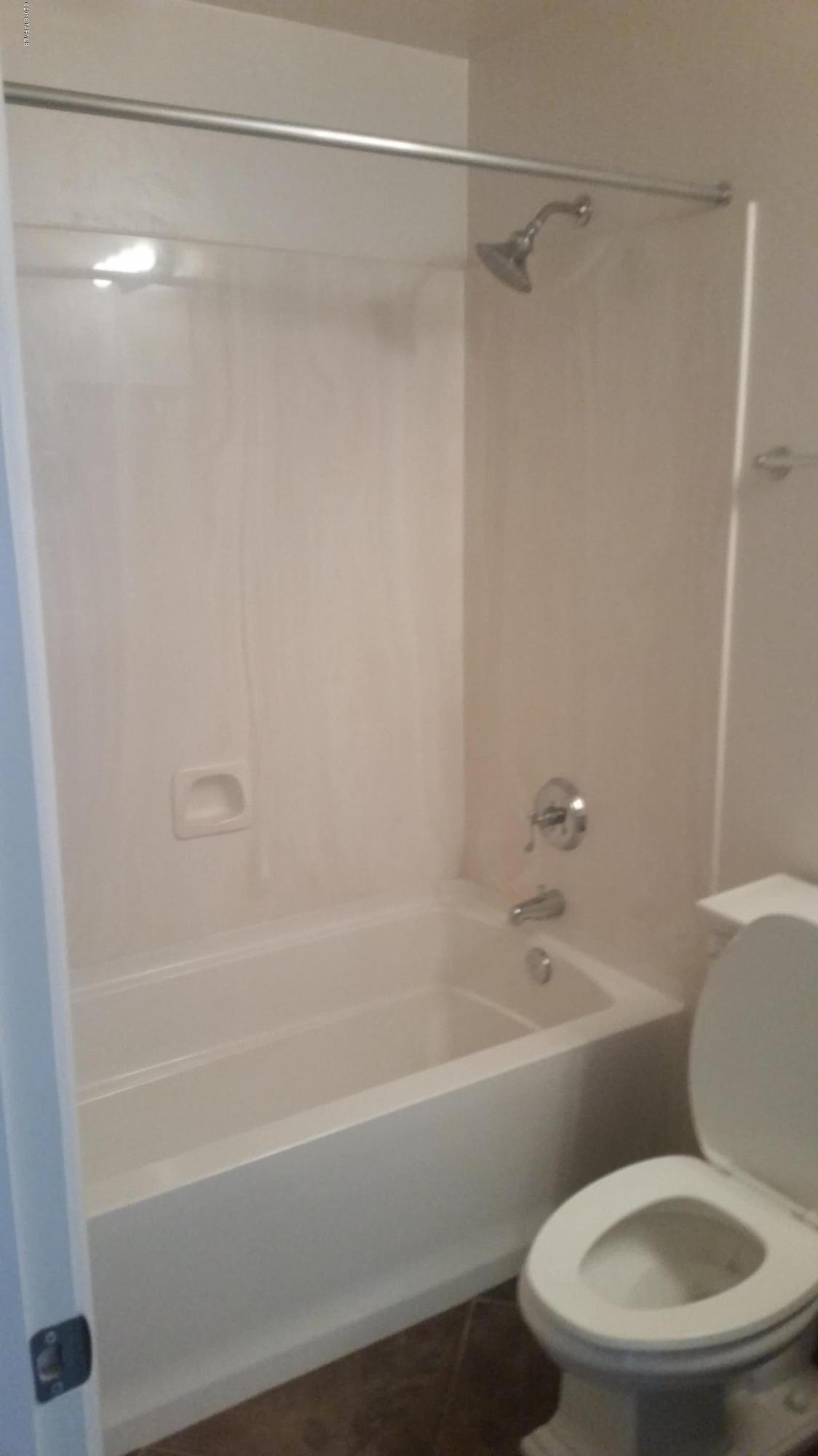 478 East Cedarvale Road Tucson, AZ 85704 - Photo 16 of 39 a white toilet and tub sitting next to a bathroom sink