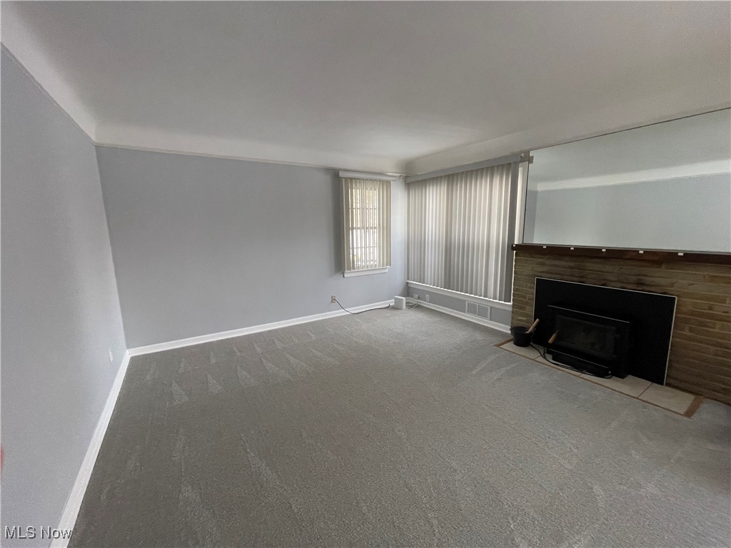 8428 Ridge Road North Royalton, OH 44133 - Photo 8 of 29 Unfurnished living room with a fireplace with flush hearth and carpet floors