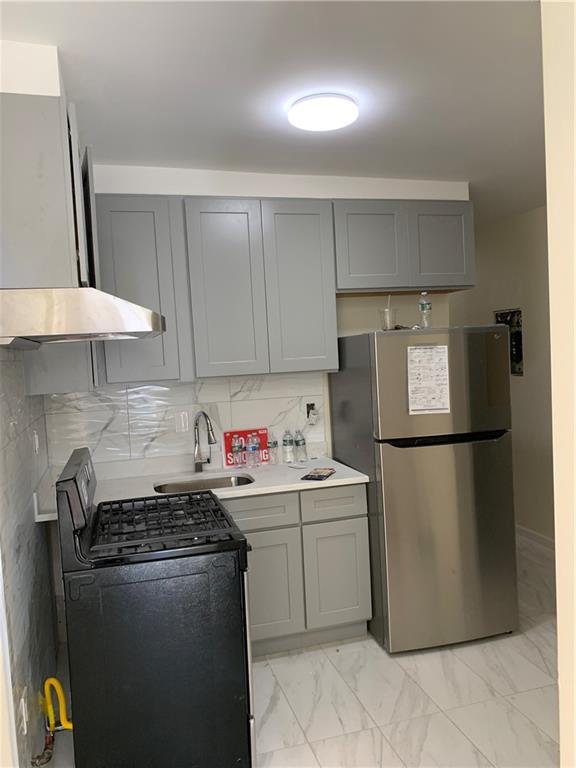 1014 Bay Ridge Parkway Brooklyn, NY 11228 - Photo 3 of 10 a kitchen with a refrigerator and a stove top oven