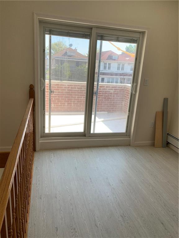 1014 Bay Ridge Parkway Brooklyn, NY 11228 - Photo 4 of 10 an empty room with wooden floor and windows