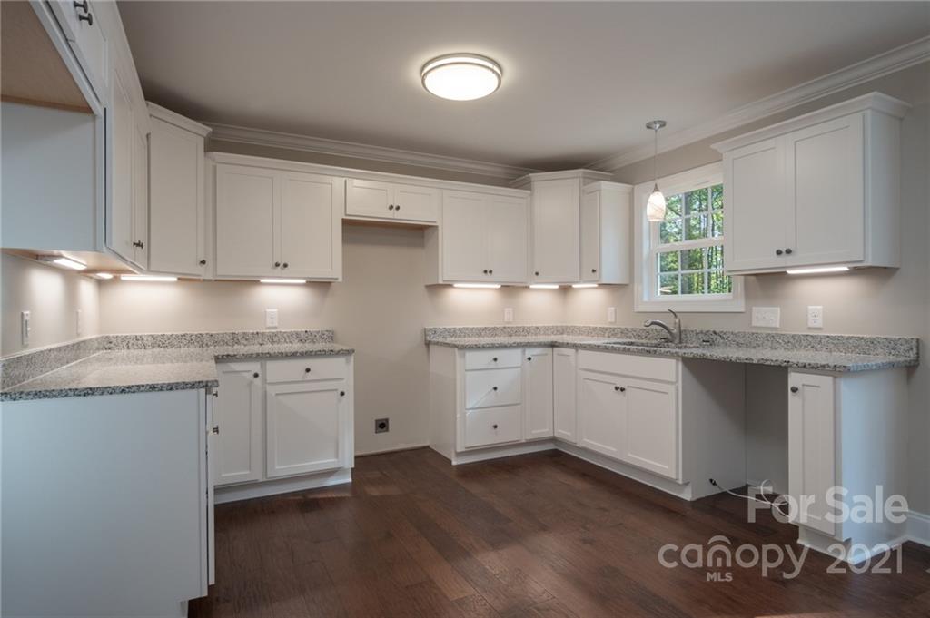 3733 Hamilton Road Edgemoor, SC 29712 - Photo 11 of 29 a kitchen with granite countertop white cabinets white appliances a sink and a window