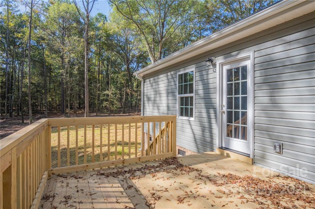 3733 Hamilton Road Edgemoor, SC 29712 - Photo 24 of 29 a view of a house with a floor to ceiling window and wooden fence
