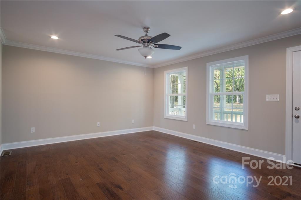 3733 Hamilton Road Edgemoor, SC 29712 - Photo 7 of 29 a view of an empty room with wooden floor and a window