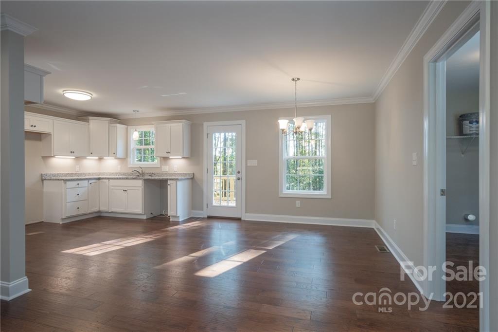 3733 Hamilton Road Edgemoor, SC 29712 - Photo 9 of 29 a view of an empty room with wooden floor and a window
