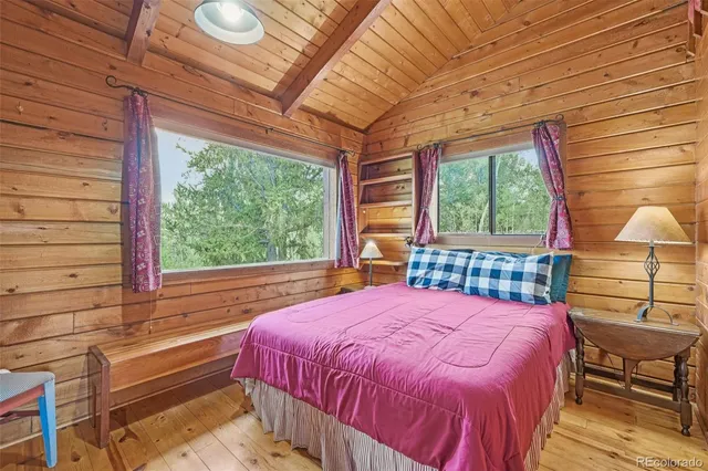a bed sitting in a bedroom next to a window