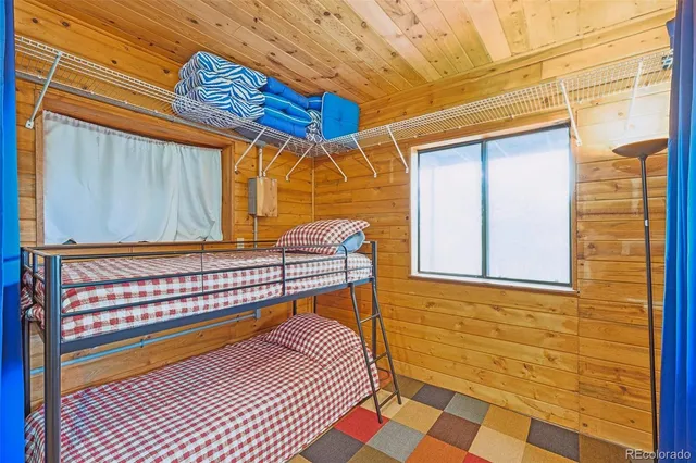 a bathroom with a granite countertop toilet sink and mirror