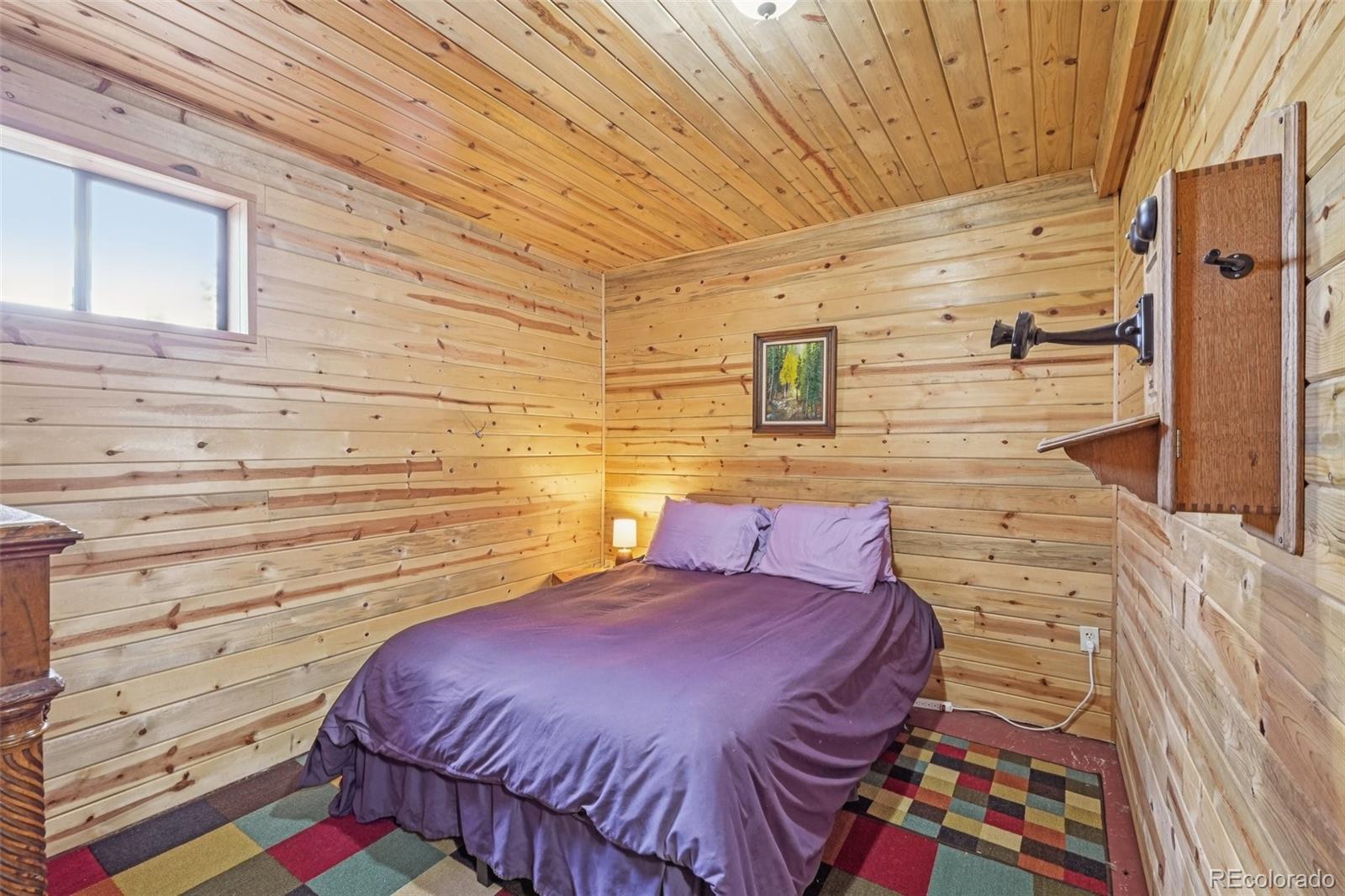 215 Gadwall Road Como, CO 80432 - Photo 24 of 39 a bedroom with a bed and a walk in closet