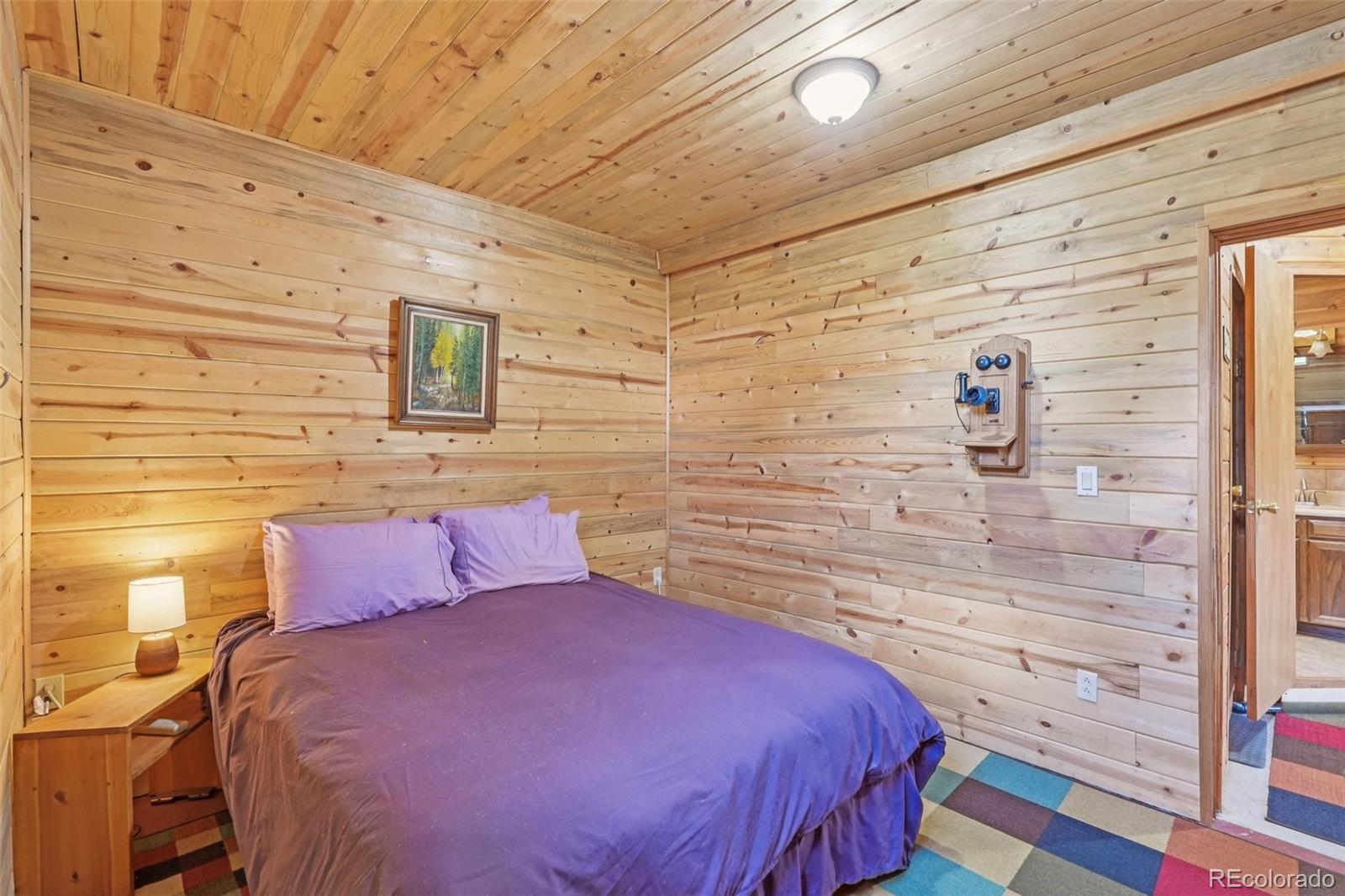 215 Gadwall Road Como, CO 80432 - Photo 25 of 39 a bedroom with a bed and a walk in closet