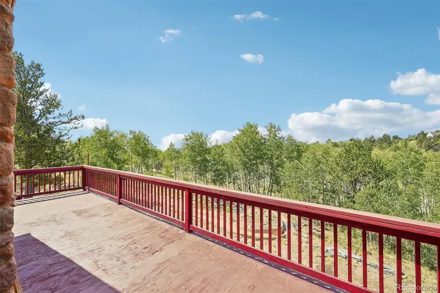 a balcony with wooden floor and fence