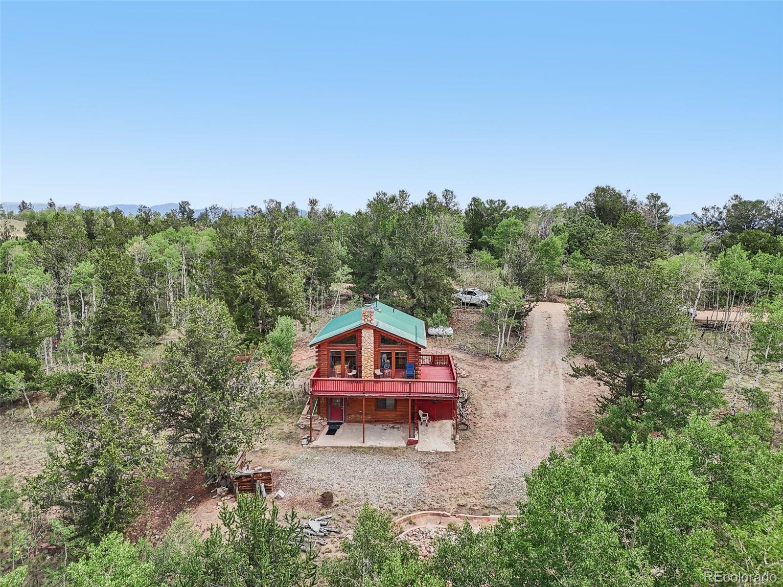 215 Gadwall Road Como, CO 80432 - Photo 3 of 39 a backyard of a house with wooden floor and yard in the back