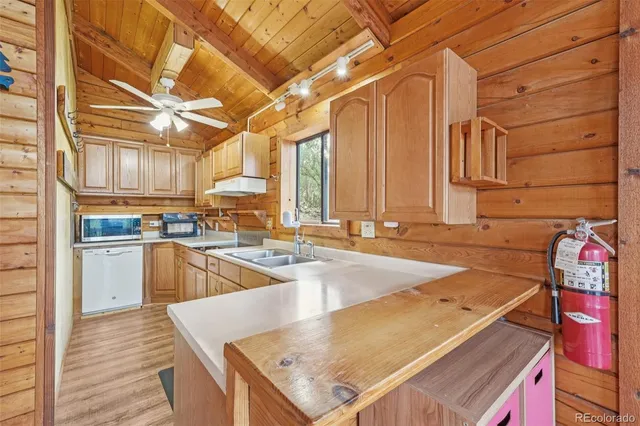a kitchen with a sink a stove and cabinets