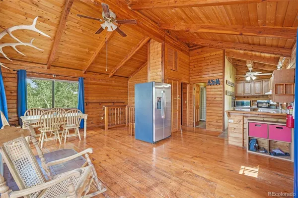 a dining room with furniture and wooden floor