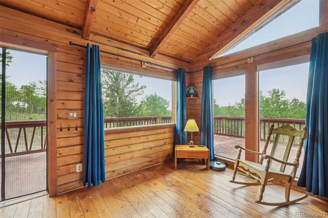 a front view of a house with wooden floor and outdoor seating