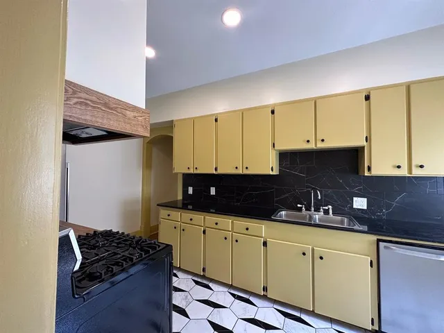 a kitchen with stainless steel appliances granite countertop a sink and cabinets