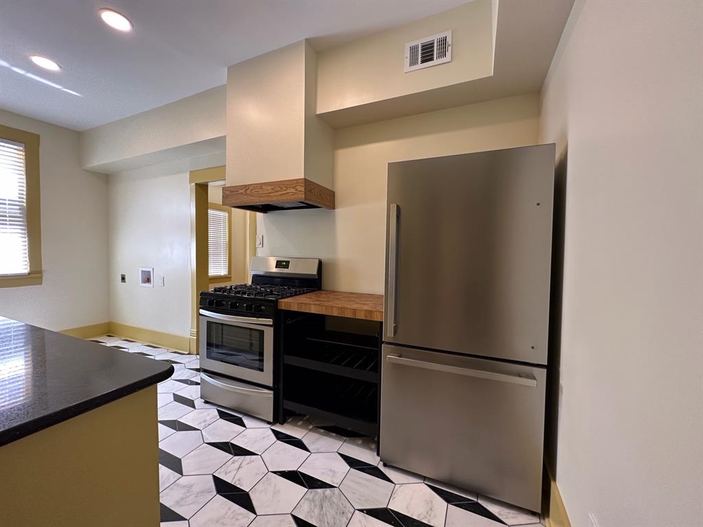 4910 Victor Street, Unit 1 Dallas, TX 75214 - Photo 13 of 30 a kitchen with stainless steel appliances a refrigerator and a stove