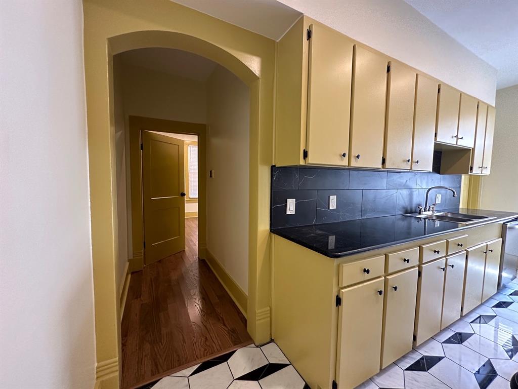 4910 Victor Street, Unit 1 Dallas, TX 75214 - Photo 16 of 30 a kitchen with granite countertop a sink and cabinets