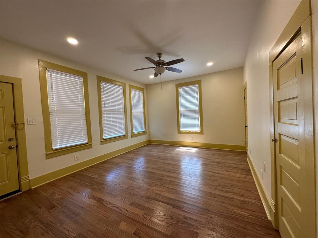 4910 Victor Street, Unit 1 Dallas, TX 75214 - Photo 17 of 30 a view of an empty room with a window and wooden floor