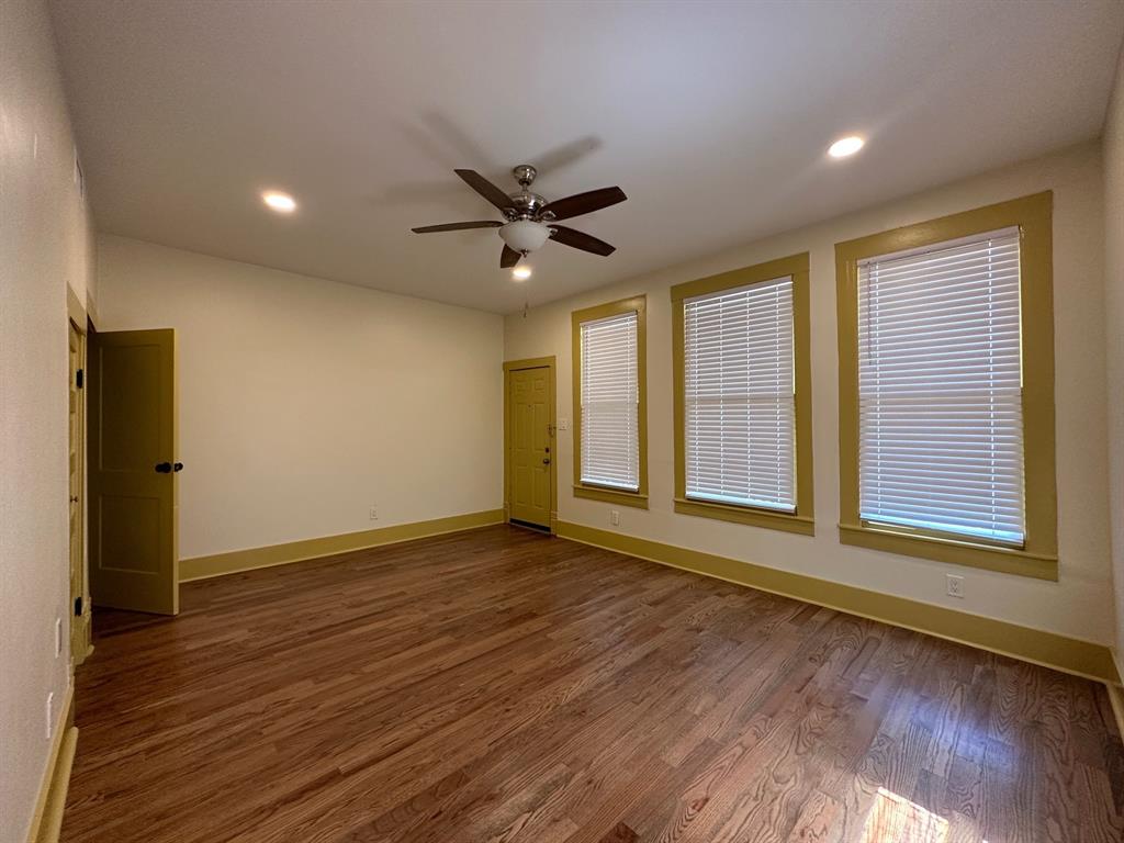 4910 Victor Street, Unit 1 Dallas, TX 75214 - Photo 18 of 30 a view of an empty room with a window and wooden floor