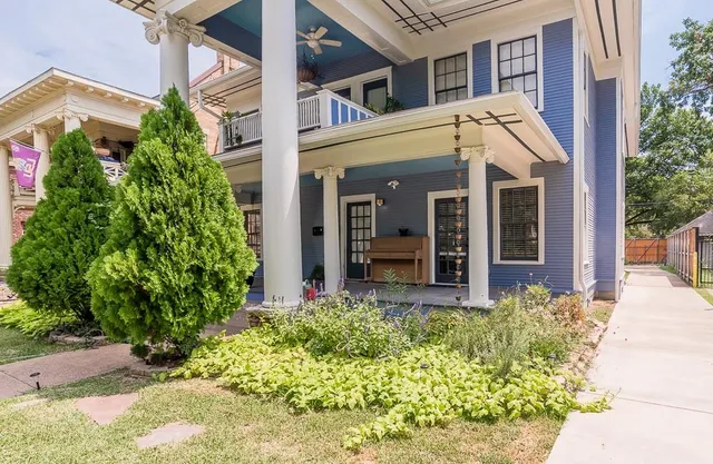 a view of a house with potted plants