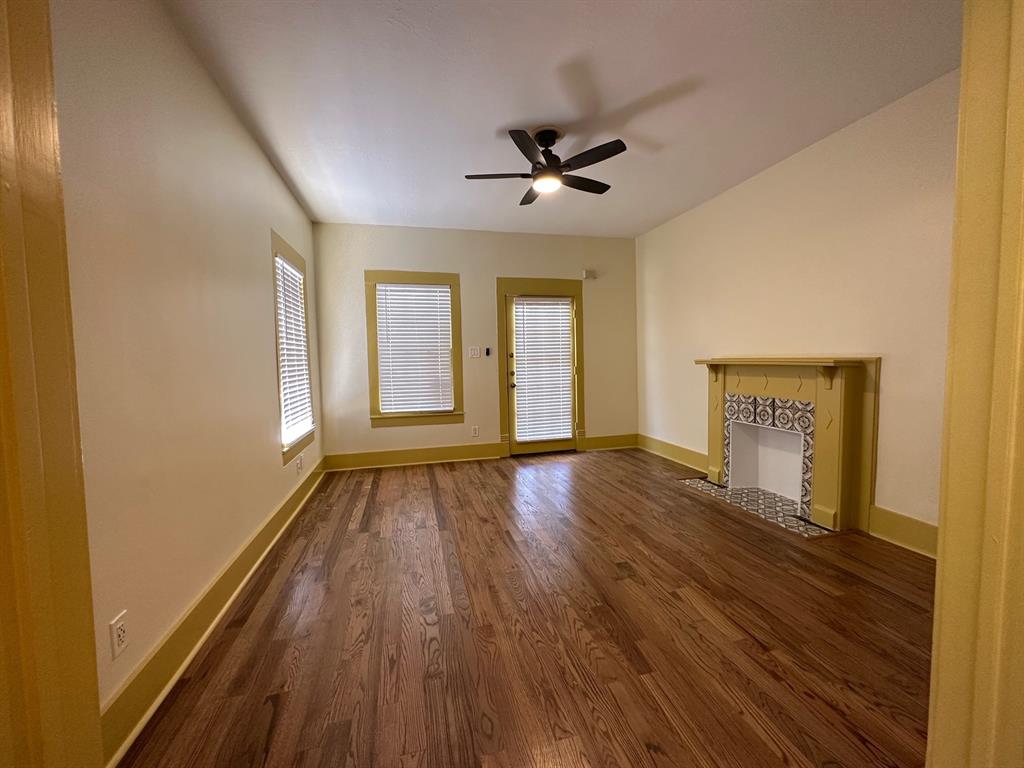 4910 Victor Street, Unit 1 Dallas, TX 75214 - Photo 3 of 30 a view of an empty room with wooden floor and a window