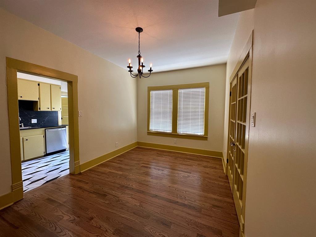 4910 Victor Street, Unit 1 Dallas, TX 75214 - Photo 9 of 30 a view of empty room with wooden floor and fan