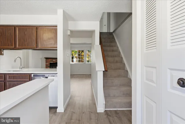 a kitchen with cabinets and wooden floor