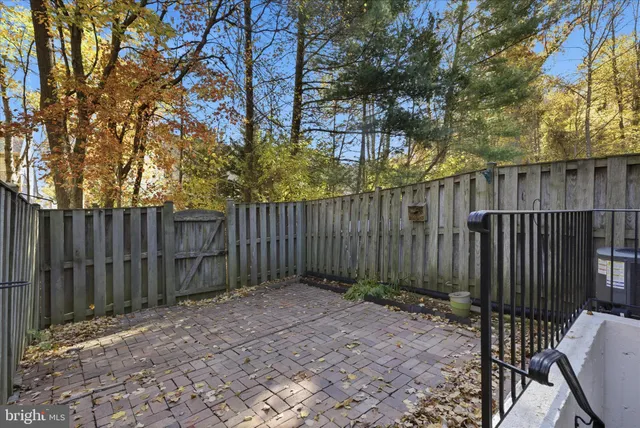 a view of backyard with wooden fence