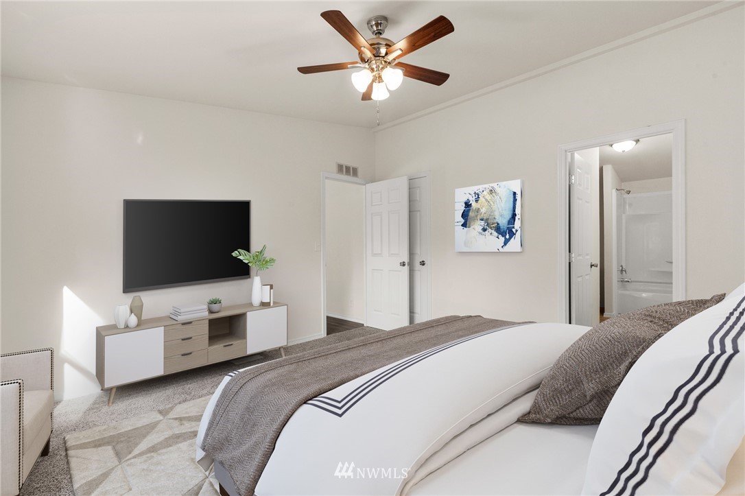 18512 Elderberry Street Southwest Rochester, WA 98579 - Photo 11 of 18 a bedroom with a bed and a flat screen tv