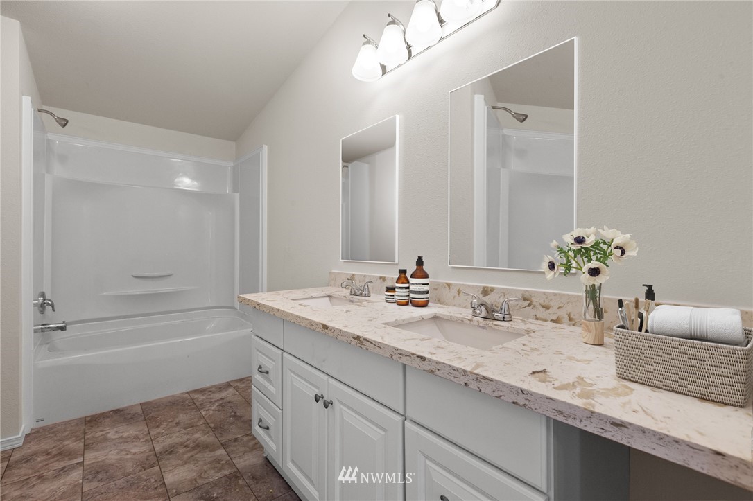 18512 Elderberry Street Southwest Rochester, WA 98579 - Photo 12 of 18 a bathroom with a granite countertop sink a toilet and shower