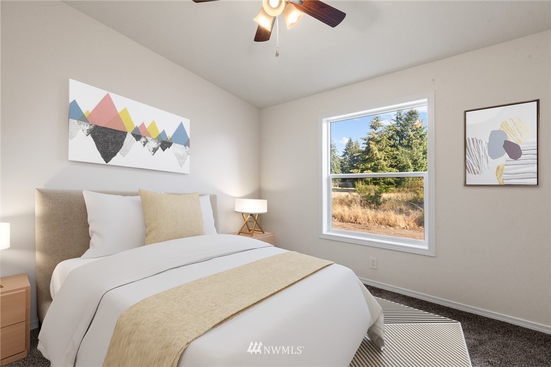 18512 Elderberry Street Southwest Rochester, WA 98579 - Photo 15 of 18 a bedroom with a large bed and a chandelier