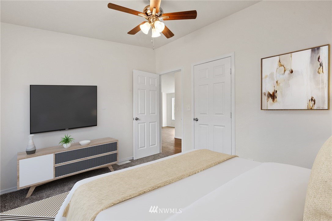 18512 Elderberry Street Southwest Rochester, WA 98579 - Photo 16 of 18 a bedroom with a bed and a flat screen tv