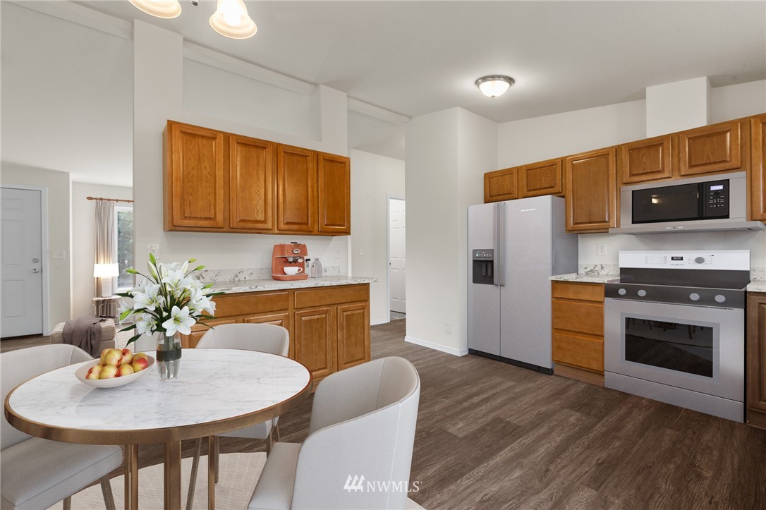 18512 Elderberry Street Southwest Rochester, WA 98579 - Photo 7 of 18 a kitchen with stainless steel appliances a stove a sink a microwave a refrigerator and wooden floor