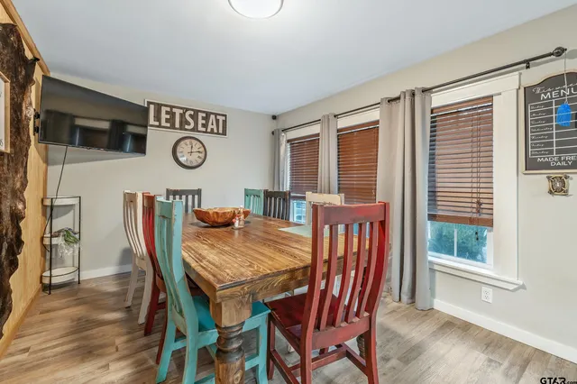 a view of a dining room with furniture and window