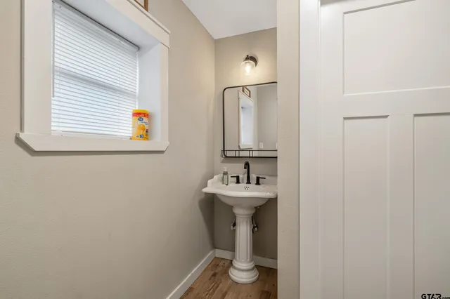 a bathroom with a sink a toilet and mirror