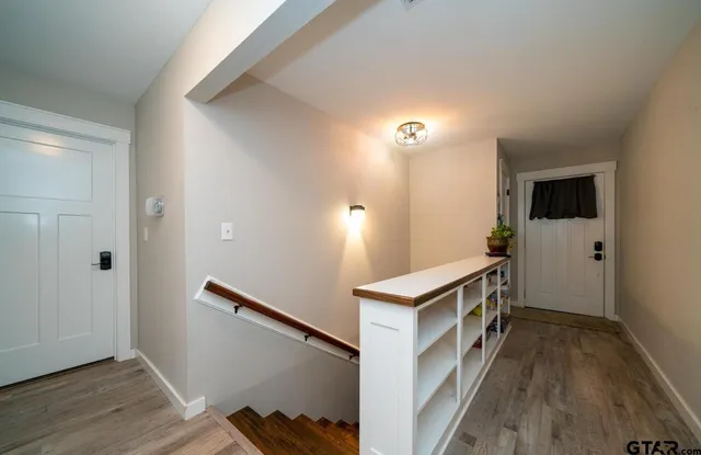 a kitchen with a stove and wooden floor