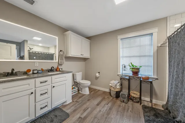 a workspace with a desk chair and painted walls with wooden floor