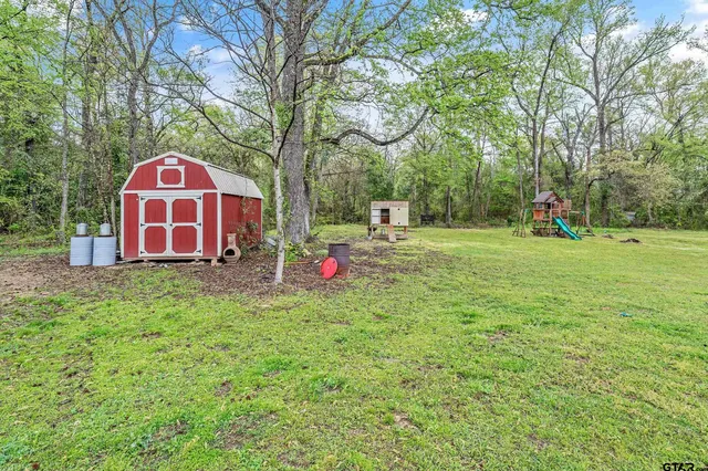 a view of a park with large trees