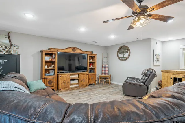 a spacious bedroom with a bed and a flat screen tv