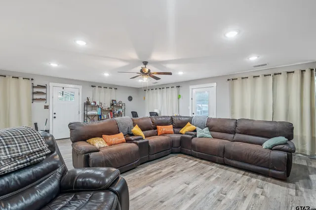 a living room with furniture and a chandelier