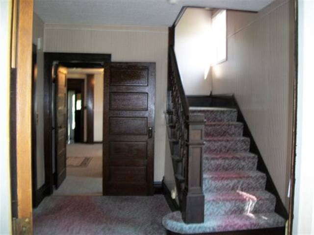 8729 South Massbach Road Elizabeth, IL 61028 - Photo 5 of 12 a view of a hallway with wooden floor and staircase