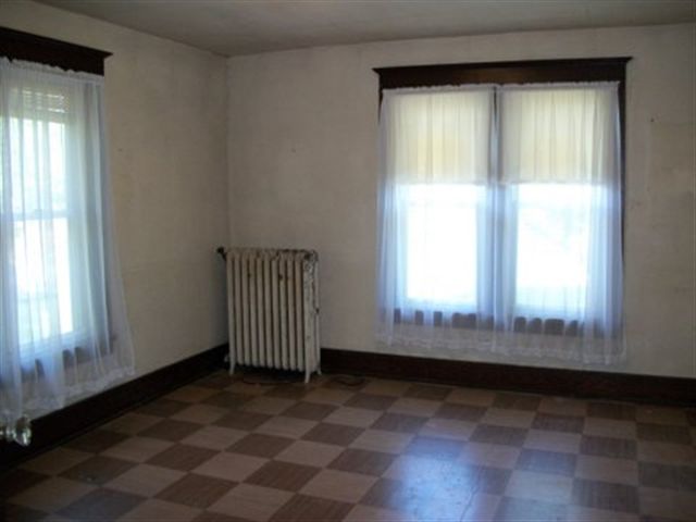8729 South Massbach Road Elizabeth, IL 61028 - Photo 7 of 12 an empty room with wooden floor and windows