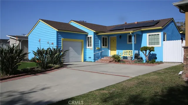 a front view of house with yard and outdoor seating